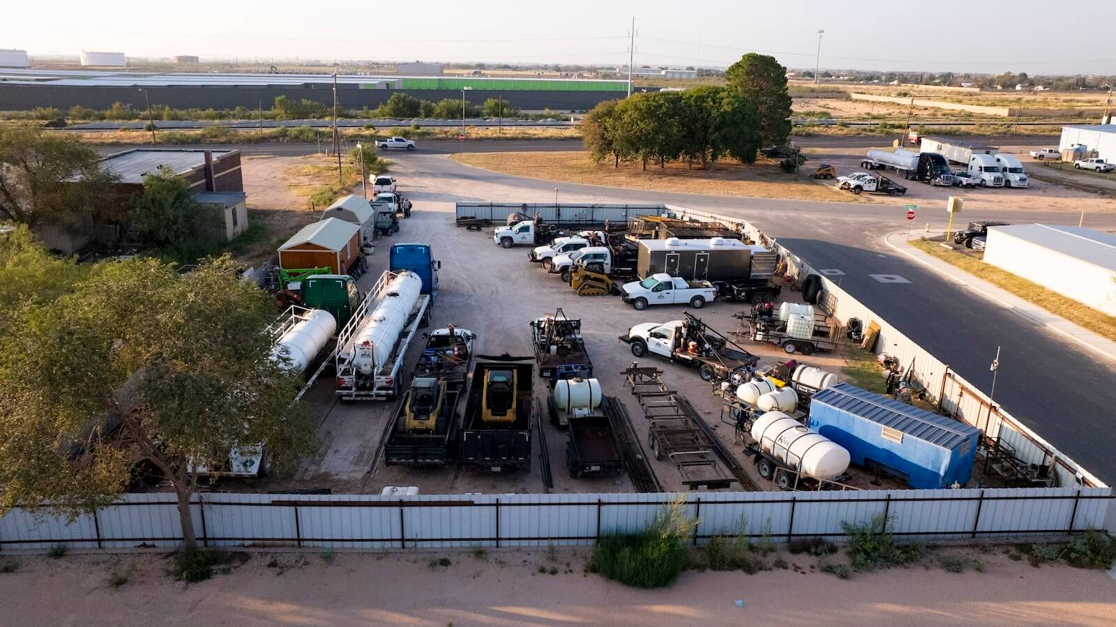 An overhead view of B&Z Construction's industrial yard with a large fleet of trucks, tanks, and heavy equipment.